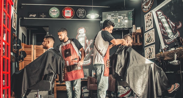 Barbers cutting hair representing hairstylist and barber online insurance